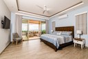 The master bedroom has a king bed with ocean views and has a sliding door that opens up to a covered outdoor lounge area.
