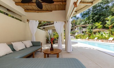 Rest area next to the pool surrounded by gardens-in Manuel Antonio for sale