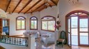 Living room with beautiful natural lighting and ceilings built with fine wood from Costa Rica