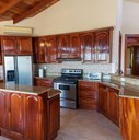 Kitchen with furniture made with fine wood and granite countertops